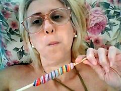 Mature pornstar Stella Still enjoys licking a lollipop in HD video