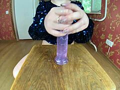 A voluptuous mature woman uses oil to enhance her rear end and pleasure herself with a sex toy at home