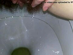 Amateur MILF gets a close-up view of her wet clit and fingering on the toilet